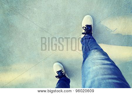 closeup of skateboarder relax legs on skatepark ramp