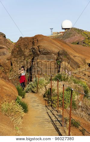 Young girl on the winding mountain trekking path at Pico do Areeiro, Madeira, Portugal