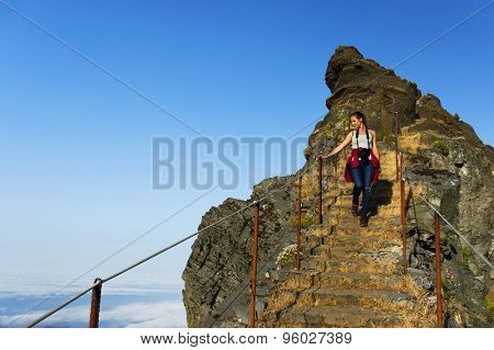 Young girl on the winding mountain trekking path at Pico do Areeiro, Madeira, Portugal