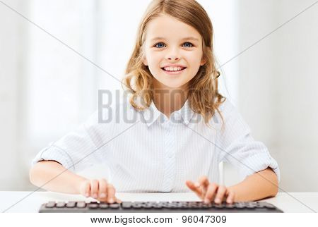 education, school and future technology concept - little student girl with keyboard and imaginary screen at school