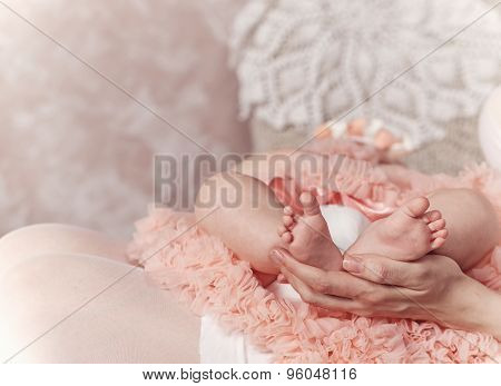 Mother Holding Feet Of Her First Child.
