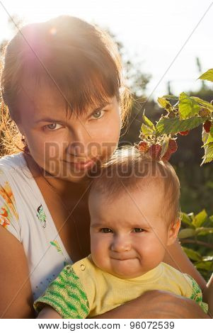 Portrait Of Young Mother With A Little Baby In The Sunny Garden. Happy Childhood And Parenthood.