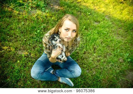 Pretty Little Husky Puppy Outdoor In Womans Hands