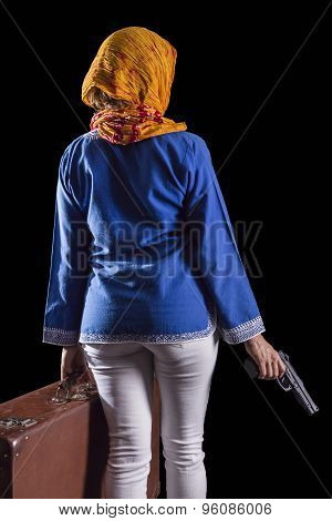 Women with Islamic headscarf subject suitcase and gun