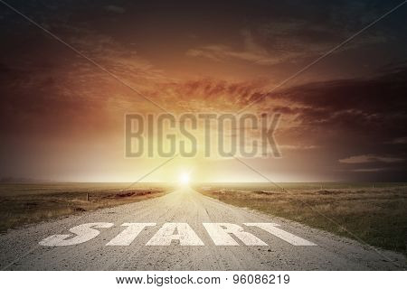 Start word on asphalt road and sunrise at horison line