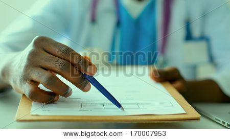 Male doctor sitting at his desk
