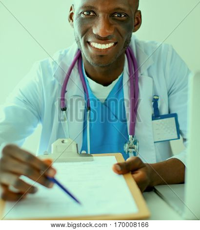 Male doctor sitting at his desk