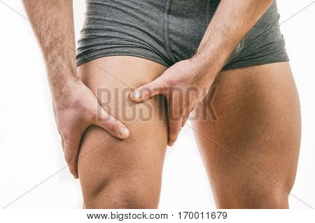 Man with quadriceps pain over white background