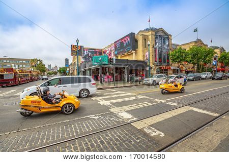 San Francisco, California, United States - August 14, 2016: GoCar Sightseeing Tour on Jefferson rd Mason st corner at Fisherman's Wharf district. Freedom and travel concept. San Francisco street view.