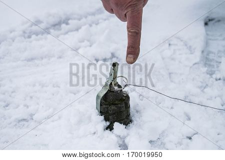The index finger shows on a land mine mine detection