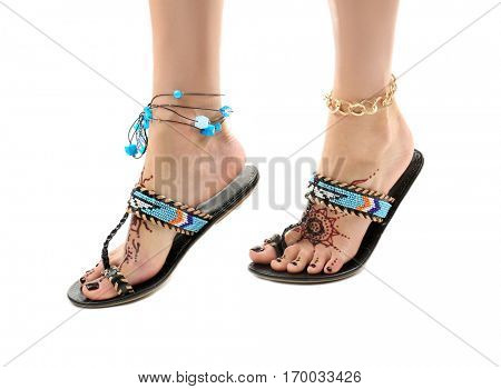 Female legs with henna tattoo, isolated on white
