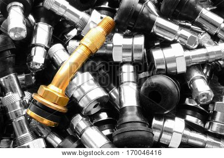 A top view image of several metal valve stems.