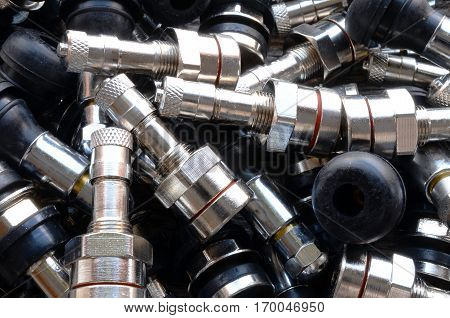 A top view image of several metal valve stems.