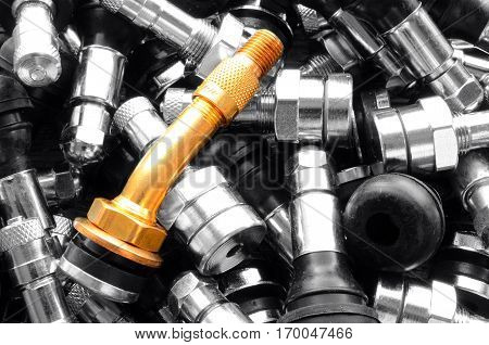 A top view image of several metal valve stems.