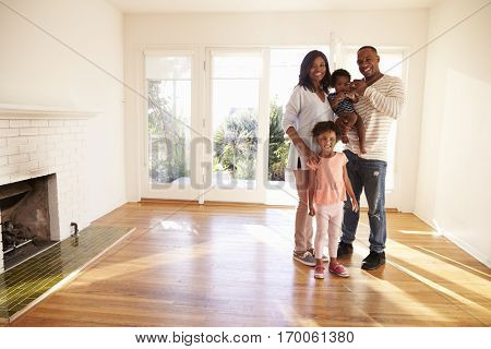 Portrait Of Family In New Home On Moving Day