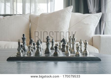 Brass Chass On Table With White Sofa Set In Living Room
