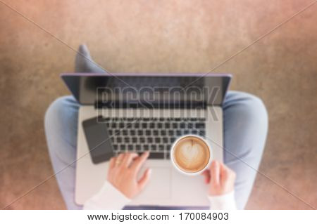 Woman sitting on floor with laptop stock photo
