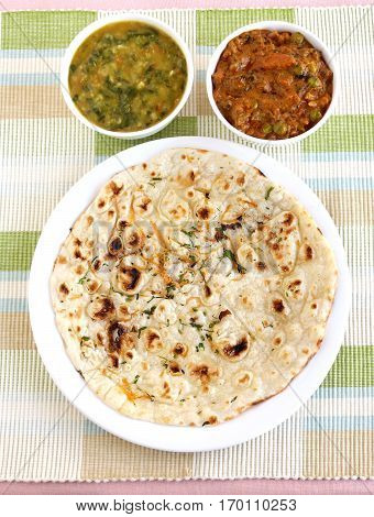 Indian food kulcha, a type of traditional and popular bread, and vegetable curries.