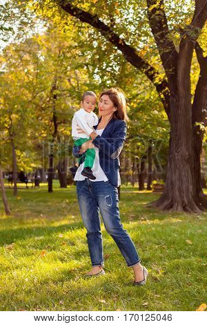 Asian Granny playing with her grandson in the Park holding him in my hands