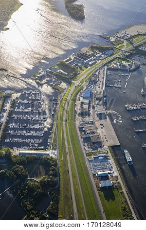 aerial view of an harbour wtih marina car park ferry boat terminal a dike Friesland the Netherlands