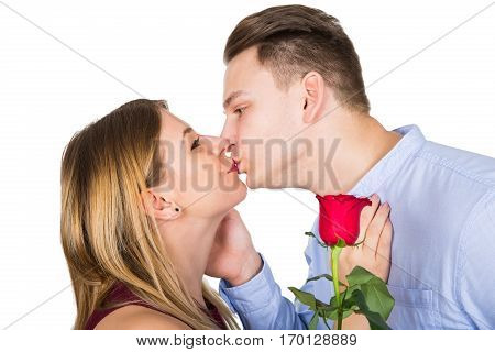 Picture of a cute young man surpirsing her girlfriend on Valentine's day