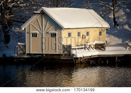 Sweedish landscape near Stockholm with a yellow wooden cabin