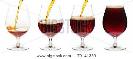 Dark ale or porter beer is pouring into snifter glass isolated on white background