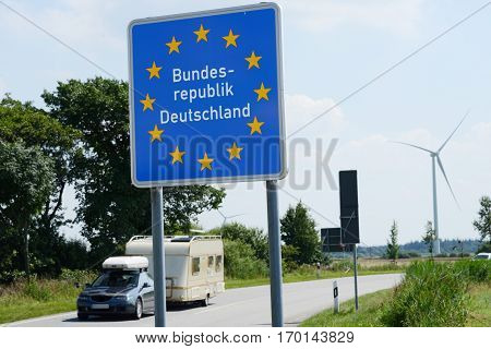 Photo with German border sign on the road.