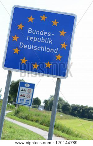 Photo with German border sign on the road.