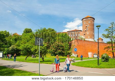 Krakow, Poland - June 08, 2016: Tourists Walking Near Historical Complex Of Royal Wawel Castle With