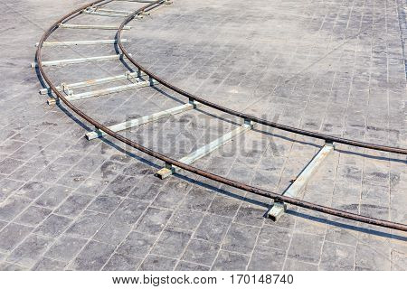 The curved part of metal dolly in outdoor location with brick floor background equipment usage for film industrial.
