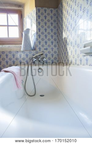 Vintage bathroom with blue tiles and enamel ewer