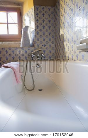Vintage bathroom with blue tiles and enamel ewer