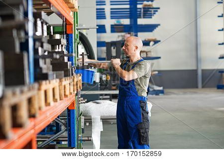 one worker in factory in stockroom- hall
