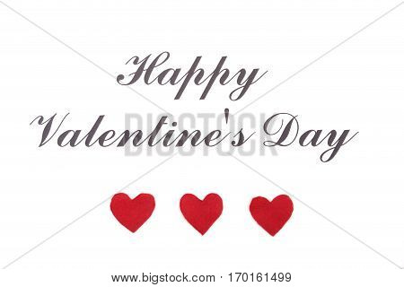 Valentine card with red heart on wooden desk.