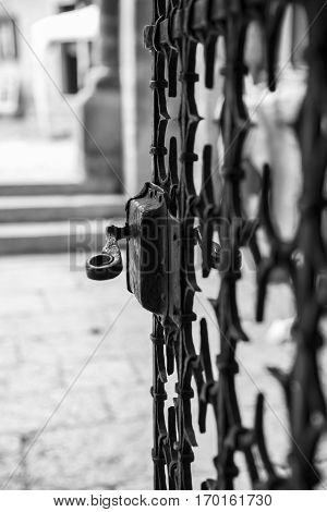 Black and white close up on the metal work of a church or castle gate