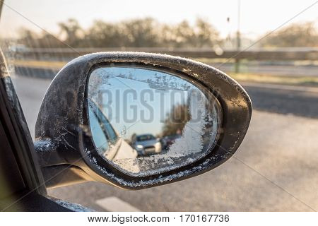 Back View Through Frozen Car Wing Mirror On Motorway