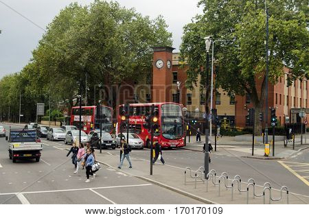 LONDON UK - SEPTEMBER 17 2016: Pedestrians crossing the road at Seven Sisters in the borough Haringey North London. Viewed on an overcast Saturday afternoon in early autumn.
