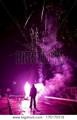People launcing firework from a rooftop in Amsterdam for the new year celebration