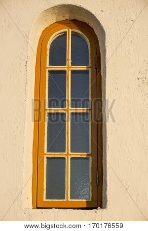 window with yellow frame on the chapel of Traena island, Norway