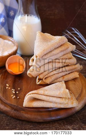Breton buckwheat crepes and ingredients on wooden table