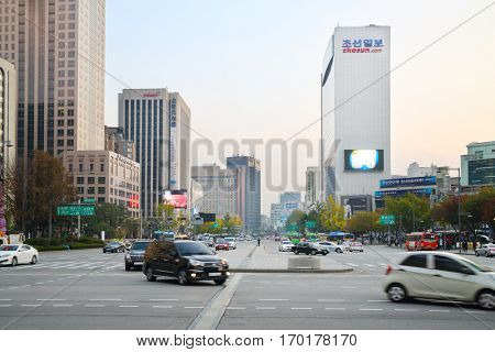 SEOUL - NOV 2, 2015: Wide avenue Sejong with driving cars, buses and highrise building among. South Korea is implementing road signs for dependent smartphones