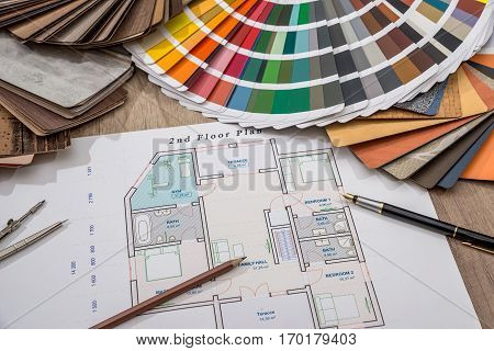 architectural drawings with palette of colors and wooden sampler for furniture designs for interior works.