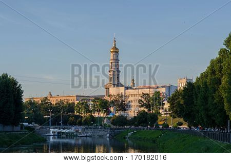 KHARKIV UKRAINE - JULY 06 2016: The bell tower of the Assumption Cathedral (Uspenskiy Sobor) philharmonic organ hall in Kharkiv Ukraine view from the river