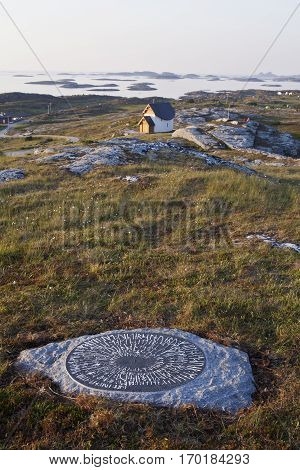 Norwegian landscape with stone with viking Runes Traena Island