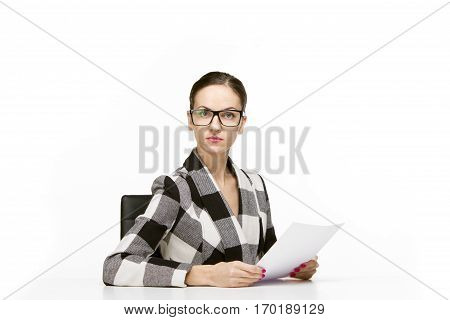 Self reliant business woman sitting at workplace with papers or documents, white background