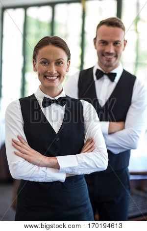 Waiting staff smiling at camera in a commercial kitchen