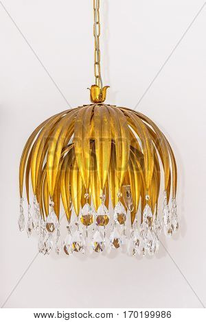 Small chandelier with crystal decorations hanging on white background