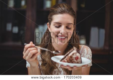 Happy woman holding desert in restaurant