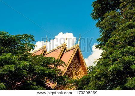 Beautiful roof, clouds and sky next to the Great Stupa in Vientiane, Laos